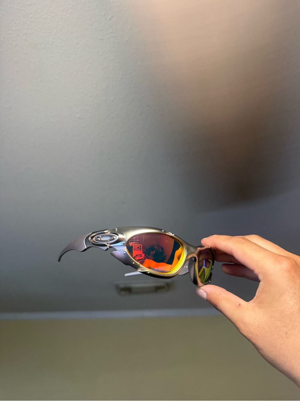 Oakley Titanium Silver Sunglasses with Red-Orange Mirror Lenses